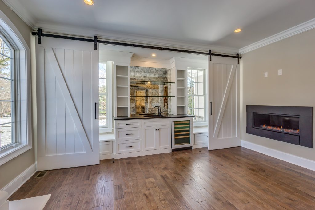 Photo of shelves with fireplace and sliding barn doors